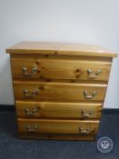 A pine four drawer chest