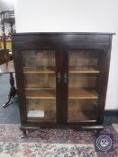 A mahogany double door bookcase fitted a drawer