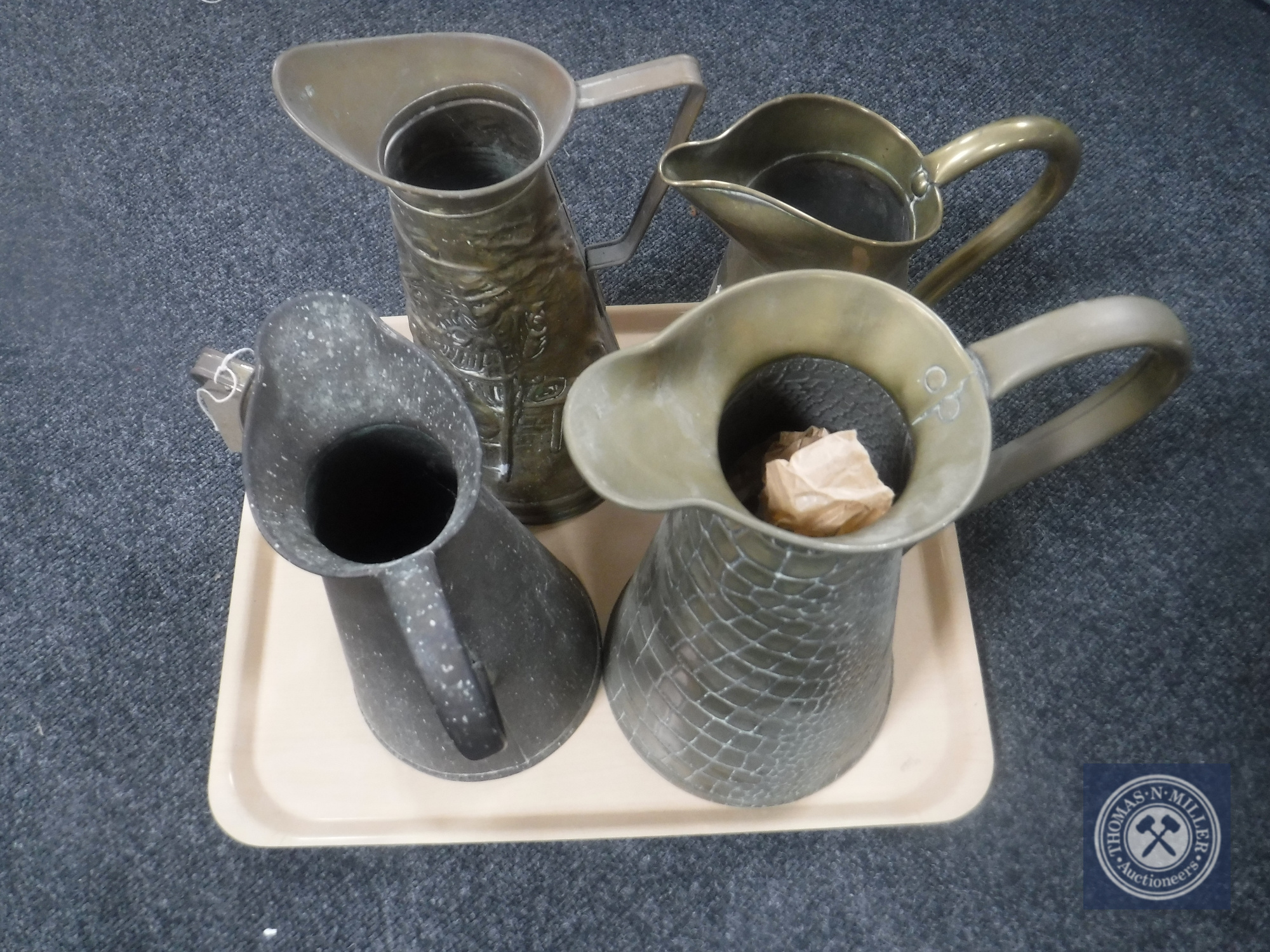 A tray of five copper and brass jugs