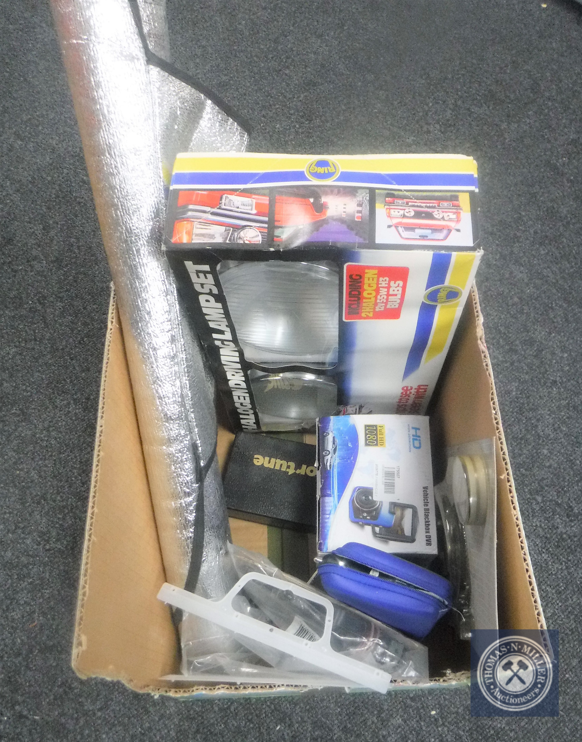 A box of car accessories, halogen driving lamps, TomTom sat nav, internal auto antenna,