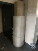 Three rolls of bubble wrap and a roll of corrugated paper