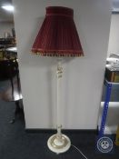 An early 20th century cream and gilt standard lamp and shade