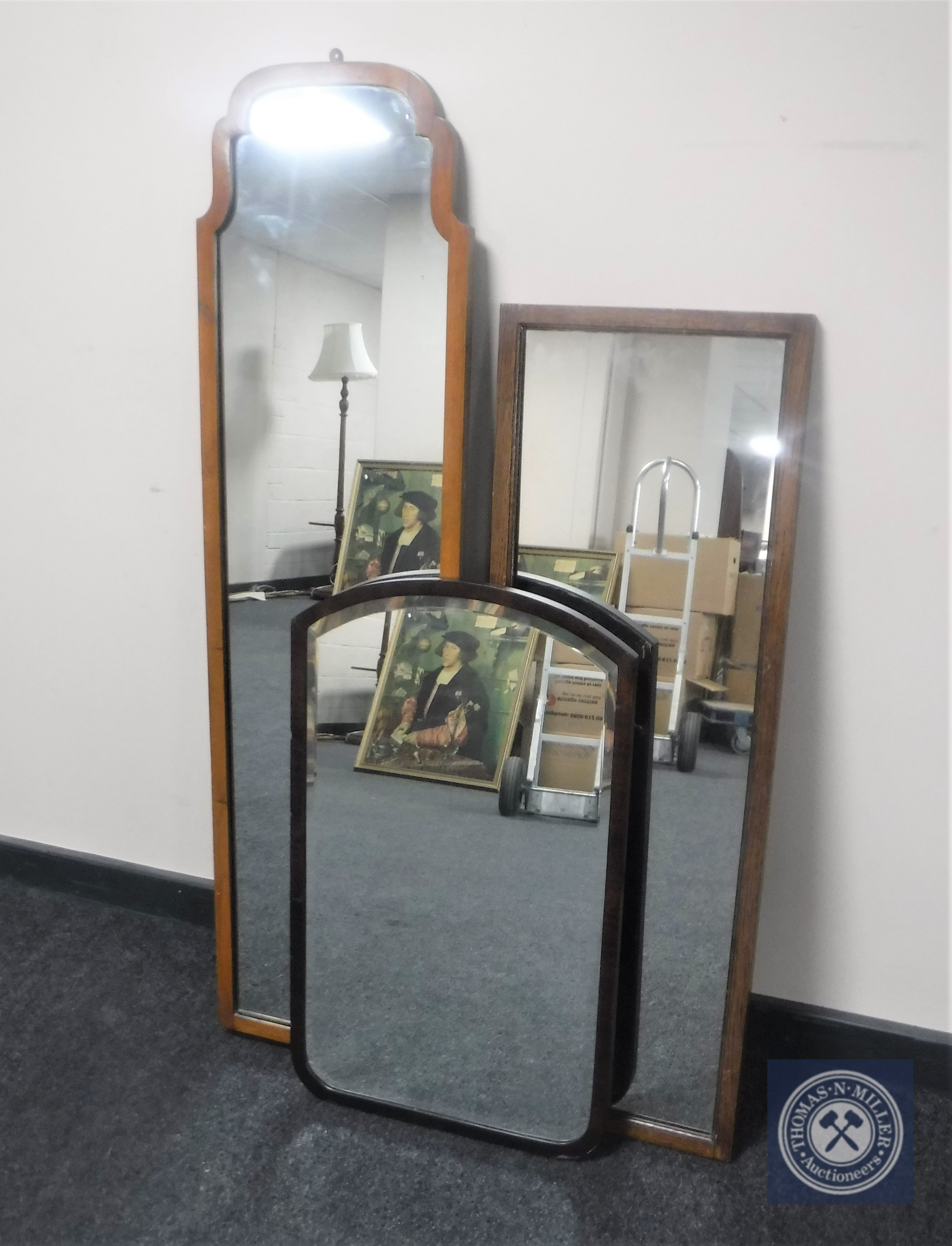 A mahogany framed hall mirror together with an oak framed hall mirror and further mahogany bevelled