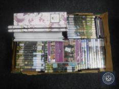 A box of Downton Abbey collection DVD's and magazines