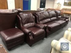 A four piece Burgundy leather high-backed lounge suite comprising of three seater settee,