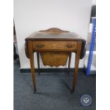 A Victorian inlaid mahogany flap sided sewing table