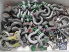 A crate of metal coupling hooks