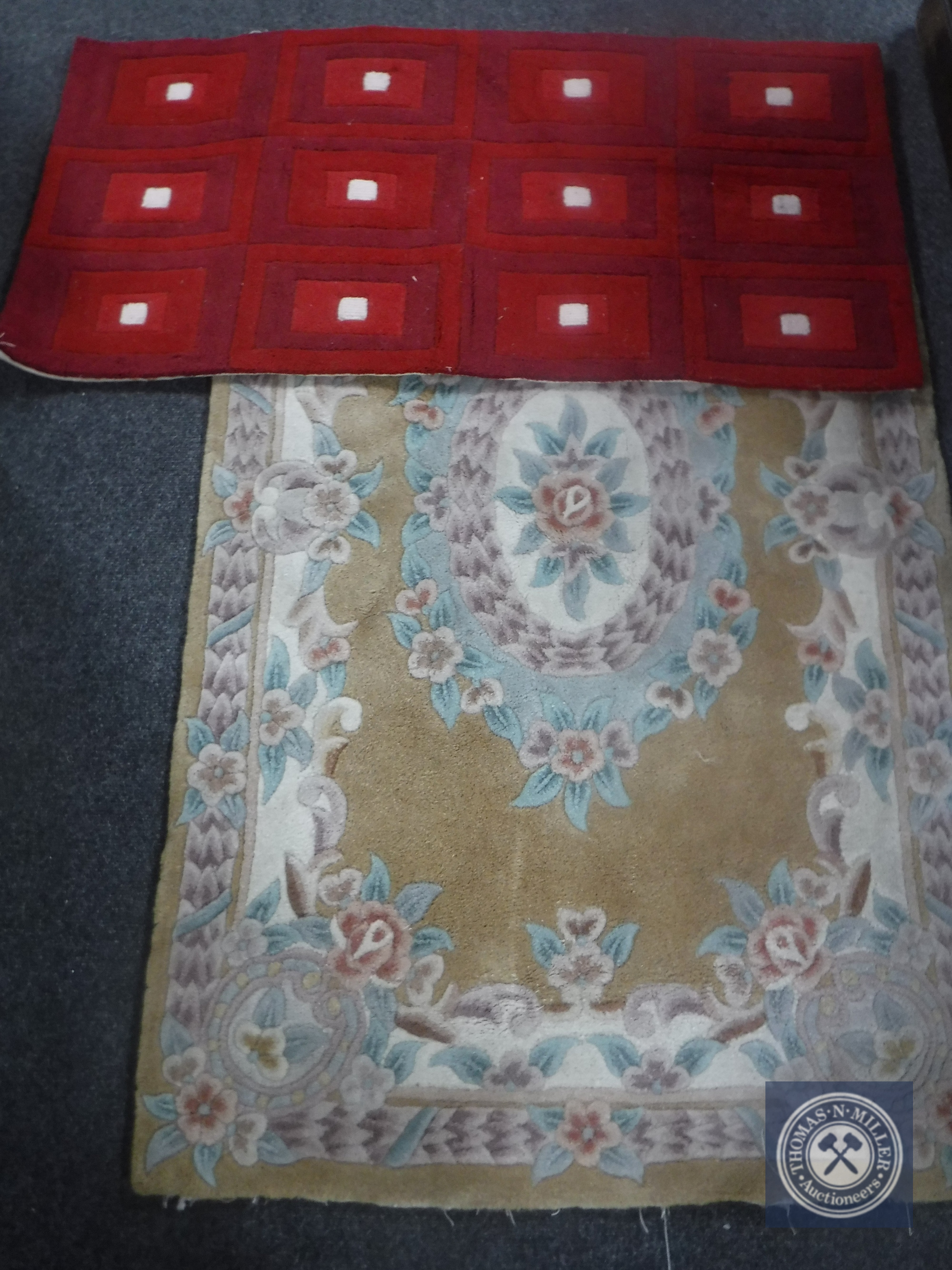 A Chinese floral rug together with a hearth rug