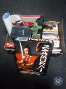 Two boxes of DVD'ss and VHS tapes relating to kung-fu, sew on patches,
