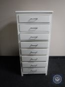 A mid 20th century painted narrow eight drawer chest