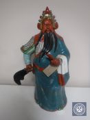 A Chinese ceramic figure with signature to base,