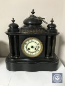 A Victorian black slate mantel clock with enamelled dial