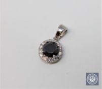 A 14ct white gold black diamond pendant featuring one round brilliant cut natural black diamond 1.