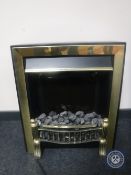 A brass framed coal effect electric fire