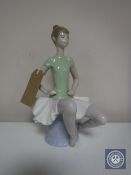 A Lladro figure - Seated ballerina