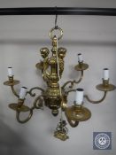 A continental brass six branch chandelier