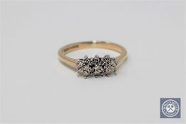 A 9ct gold seventeen stone diamond cluster ring, size J.