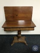 A 19th century continental mahogany foldover top tea table