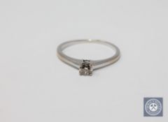 An 18ct white gold round cut diamond solitaire ring, approximately 0.25ct, size P.