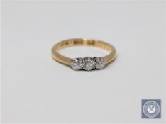 An 18ct gold three stone ring, approximately 0.33ct, size K.