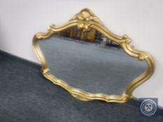 An ornate gilt framed overmantel mirror