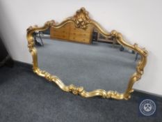 An ornate gilt framed overmantel mirror