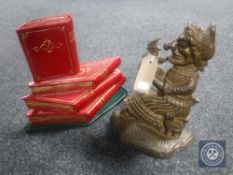 Two cast iron door stops - Judy and a stack of books