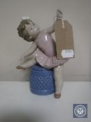 A Lladro figure - Baby ballerina on stool