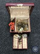 A Burgundy leather jewellery box containing various costume jewellery, watches etc.