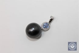 A 14ct white gold pearl and diamond pendant featuring one cultured Tahitian pearl with one oval cut