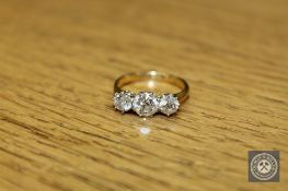 An 18ct gold three-stone diamond ring,
