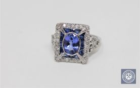 An 18ct white gold tanzanite sapphire and diamond ring, oval cut bezel set with natural tanzanite 0.