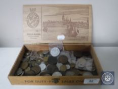 A wooden cigar box containing British and foreign coins
