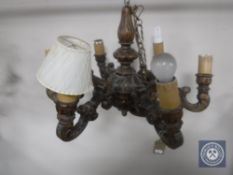 A continental carved pine six branch chandelier