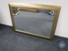 A contemporary gilt framed bevelled overmantel mirror