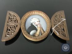 A portrait miniature of a pretty girl painted on porcelain with wooden picture frame fretwork and