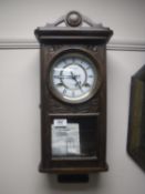 An oak cased President 31 day wall clock