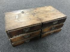 An antique pine counter top six drawer storage chest