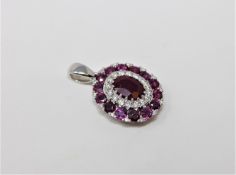 A 14ct white gold ruby and diamond pendant,