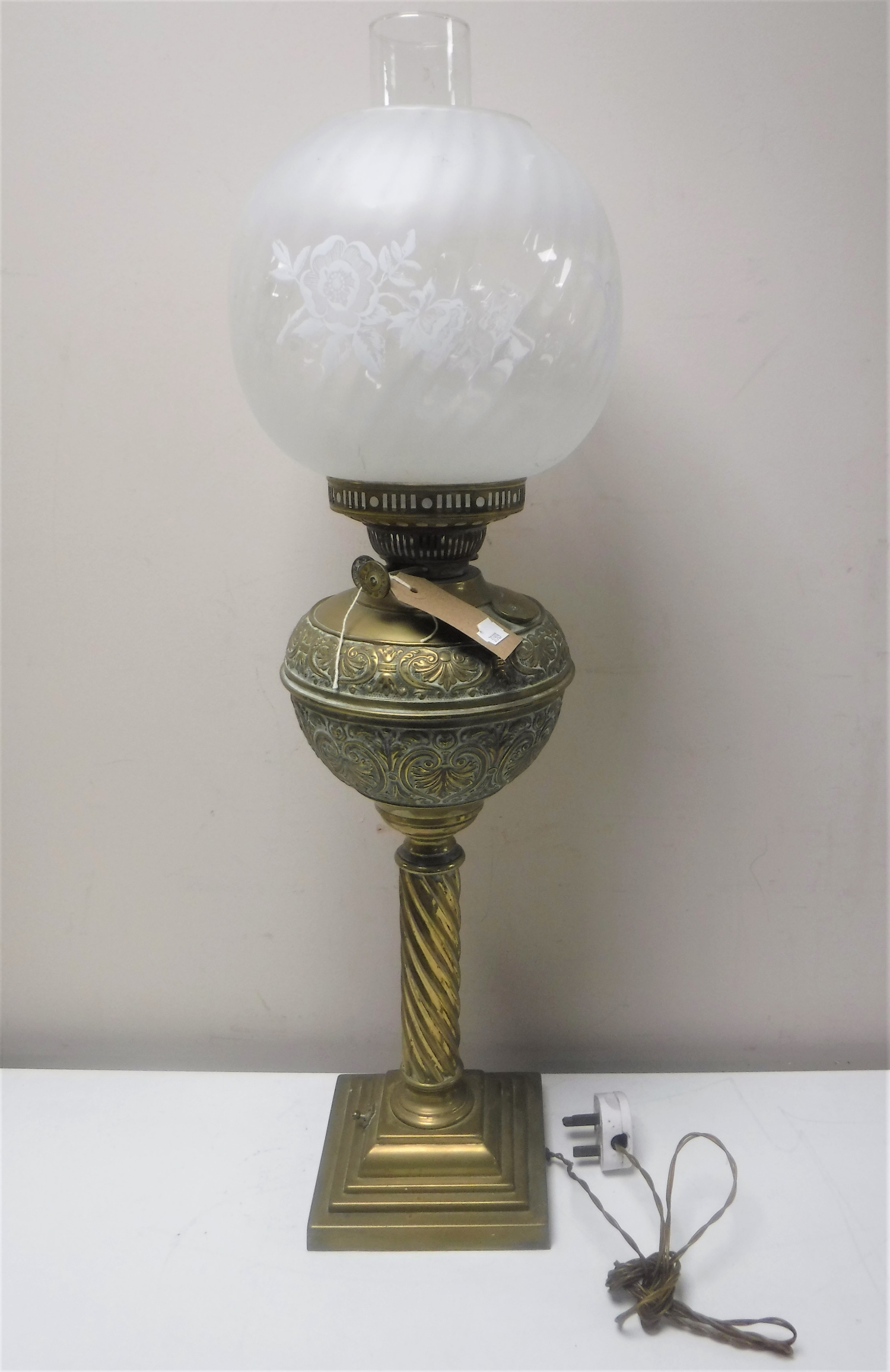 A Victorian brass twist column oil lamp with glass chimney and shade (converted)