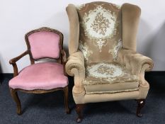 A wingback armchair upholstered in a gold floral fabric together with a salon armchair in pink