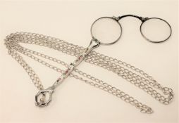 An antique silver and enamelled lorgnette upon a long silver guard chain, length approx.