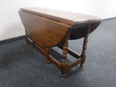 A stained pine farmhouse drop leaf kitchen table