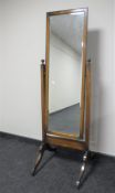 An Edwardian oak cheval mirror on stand