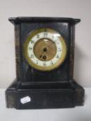 A Victorian slate brass mantel clock with brass and enamelled dial