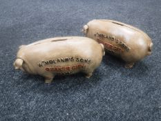 Two cast iron pig money boxes