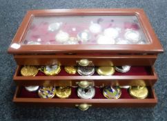 A contemporary counter top pocket watch display cabinet containing modern pocket watches