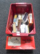 A box of HO Scale die cast models and three N gauge building kits