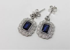 A pair of 14ct white gold sapphire and diamond earrings featuring 2 cushion cut sapphires 2.