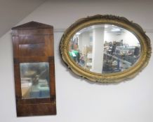 An early 20th century oval gilt framed bevelled edge mirror together with an antique mahogany hall